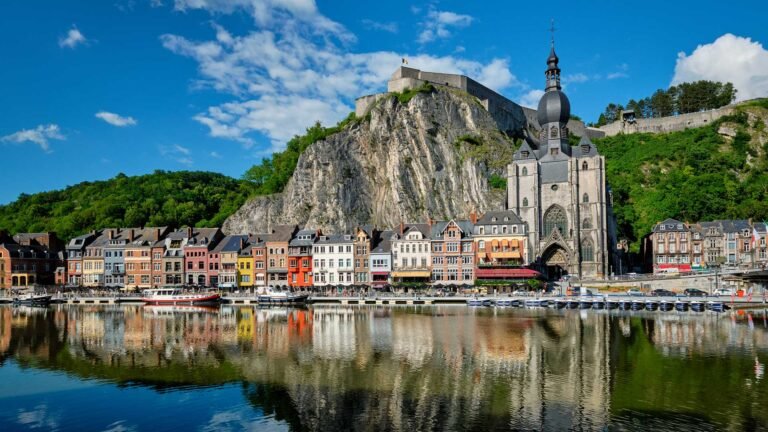 # Dinant – Belgium's Riverside Gem Nestled along the banks of the Meuse River and surrounded by dramatic limestone cliffs, Dinant is one of Belgium's most picturesque and charming destinations. Known for its stunning riverside setting, rich history, impressive citadel, and unique cultural heritage, Dinant offers visitors a perfect blend of natural beauty and Belgian charm. Often considered one of the most beautiful towns in Belgium, Dinant captivates visitors with its colorful waterfront, historic landmarks, and breathtaking scenery. ## A Spectacular Setting on the Meuse River Dinant's location is truly extraordinary. The town is squeezed between steep cliffs and the Meuse River, creating one of the most dramatic urban landscapes in Belgium. Colorful buildings line the riverbank while towering rock formations rise above the town, making Dinant instantly recognizable. The river remains at the heart of local life and offers beautiful views from every angle. ## The Iconic Citadel of Dinant High above the town stands the famous Citadel of Dinant. Perched on a rocky cliff overlooking the Meuse Valley, the fortress has protected the region for centuries. Visitors can reach the citadel by cable car or climb the historic staircase of over 400 steps. From the top, spectacular panoramic views stretch across the town, river, and surrounding countryside. The citadel remains Dinant's most visited attraction. ## The Collegiate Church of Notre-Dame At the foot of the cliffs stands the stunning Collegiate Church of Notre-Dame. Its striking Gothic architecture and distinctive onion-shaped bell tower dominate the town's skyline. The church is one of Belgium's most photographed religious landmarks and serves as a symbol of Dinant's resilience throughout its long history. The dramatic backdrop of cliffs behind the church creates an unforgettable scene. ## Birthplace of the Saxophone Dinant holds a special place in music history as the birthplace of Adolphe Sax, inventor of the saxophone. Visitors can explore the connection through statues, exhibitions, and colorful saxophone sculptures displayed throughout the town. Music lovers from around the world visit Dinant to celebrate the legacy of one of Belgium's most famous inventors. ## Explore the Meuse by Boat One of the best ways to experience Dinant is from the water. River cruises and boat tours provide stunning views of the town, the citadel, and the surrounding cliffs. The Meuse River offers a peaceful perspective on the region's natural beauty and historical landmarks. A boat trip is often one of the highlights of a visit. ## Stunning Natural Surroundings Dinant is surrounded by beautiful countryside and dramatic landscapes. Visitors can enjoy: * Hiking trails * Cycling routes * River cruises * Rock formations * Forest walks * Scenic viewpoints * Outdoor adventures The region is particularly popular among nature lovers and photographers. ## Belgian Cuisine and Local Specialties Dinant offers a wonderful introduction to Belgian gastronomy. Visitors can enjoy: * Belgian waffles * Local cheeses * Traditional Belgian dishes * Craft beers * Chocolate specialties * Regional desserts One of the town's unique treats is the famous Couque de Dinant, a traditional hard biscuit that has been produced locally for centuries. ## Gateway to the Ardennes Dinant is often considered one of the gateways to the beautiful Ardennes region. The surrounding area features rolling hills, forests, castles, charming villages, and outdoor recreation opportunities that attract visitors throughout the year. The combination of history and nature makes the region especially appealing. ## Perfect for a Relaxing Escape Unlike larger European cities, Dinant offers a relaxed and welcoming atmosphere. Visitors can spend their days strolling along the riverfront, enjoying local cafés, exploring historic landmarks, and taking in the peaceful scenery that surrounds the town. Its compact size makes it ideal for a day trip or a longer stay. ## Stay Connected While Exploring Belgium Whether you're sharing photos of the citadel, exploring the Meuse Valley, enjoying a river cruise, working remotely from a Belgian café, or touring Europe in your motorhome, reliable mobile internet helps you stay connected throughout your journey. ## Why Dinant Should Be on Your Belgium Itinerary Dinant combines everything travelers love about Belgium: history, culture, beautiful architecture, stunning landscapes, and warm hospitality. From its famous citadel and riverside charm to its musical heritage and spectacular scenery, Dinant offers an unforgettable experience that feels both authentic and uniquely Belgian. For visitors seeking one of Belgium's most beautiful destinations, Dinant is a true hidden gem.